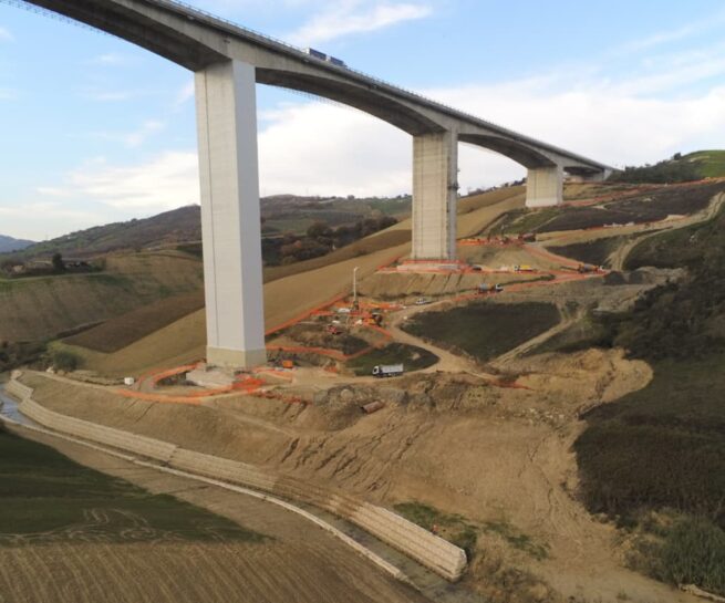 Viadotto Cerrano: ponte su una collina con attrezzature di costruzione. Sottoposto a un rigoroso processo di monitoraggio e controllo per garantire la sicurezza strutturale. Progetto di stabilizzazione completato nel 2022 per mitigare i rischi di cedimento del terreno.